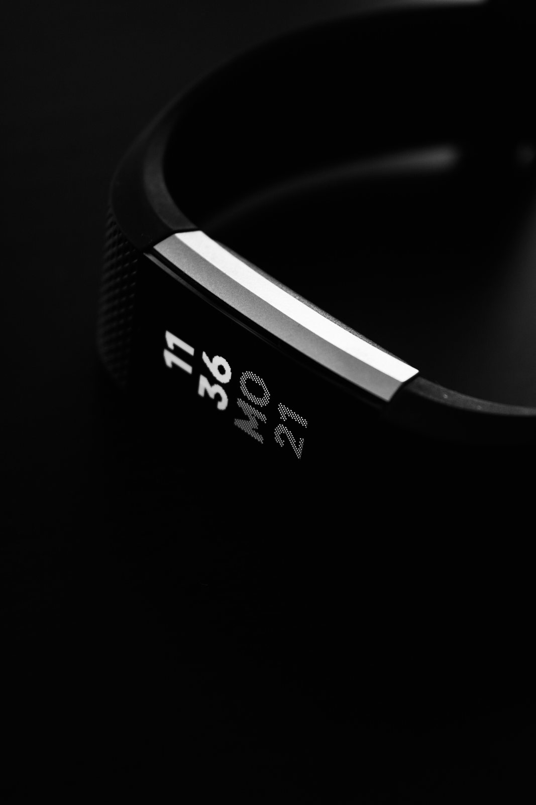 A fitness band showing the time, in black and white